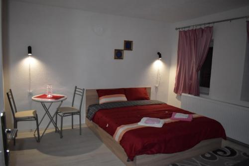 1 dormitorio con 1 cama y 1 mesa con sillas en Villa DIJA, en Kruševo
