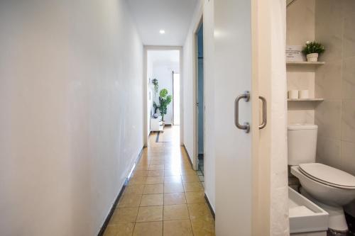 a bathroom with a toilet and a hallway at 31PAR1008 - Mediterranean style apartment in Barcelona
