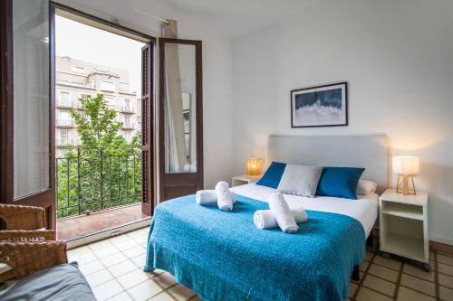 a bedroom with a bed and a large window at 31PAR1008 - Mediterranean style apartment in Barcelona