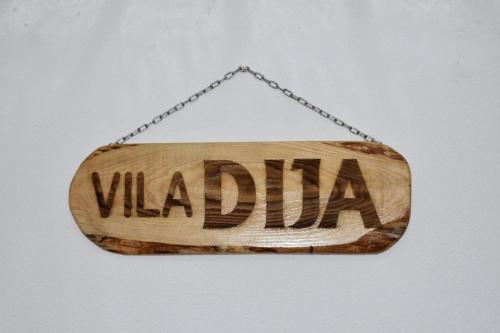 a wooden sign with the word vida hanging on a chain at Villa DIJA in Kruševo