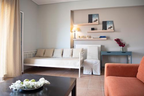 a living room with a couch and a table at Nest Aegina Apartments in Perdika
