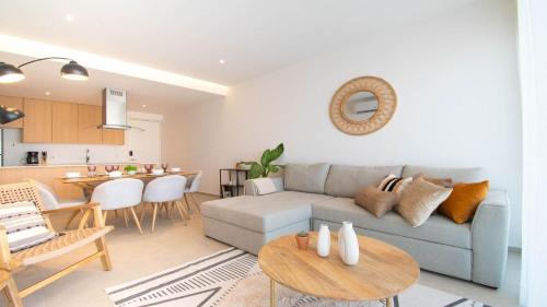 a living room with a couch and a table at Brand New Condo Aria Ocean 614 by Kivoya in Nuevo Vallarta