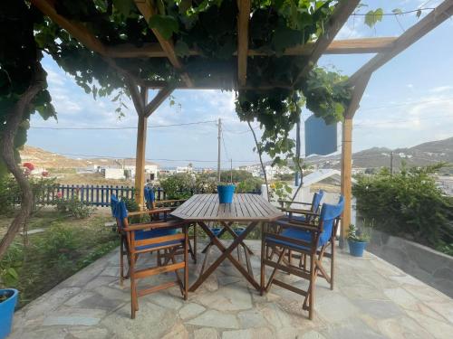 a wooden table and chairs on a patio at ANESIS I in Livadion