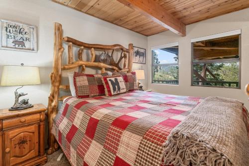 a bedroom with a bed and a night stand with a lamp at Wolf View Lodge - Adorable and modern cabin with well-appointed mountain decor in Big Bear Lake