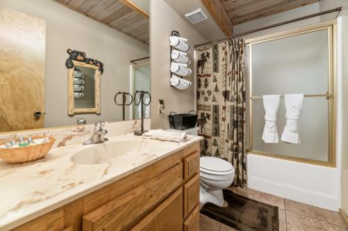 a bathroom with a sink and a toilet at Wolf View Lodge - Adorable and modern cabin with well-appointed mountain decor in Big Bear Lake