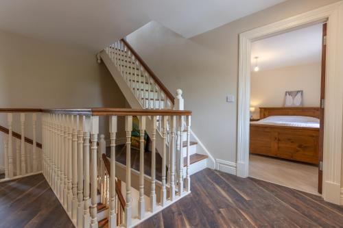 a staircase leading to a bedroom with a bed at Bellair House in Cluain na Slí