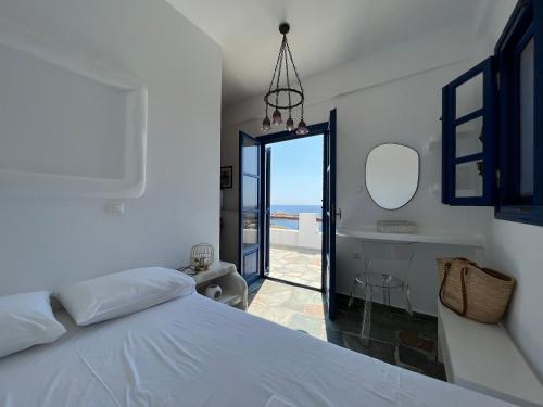 a bedroom with a bed and a view of the ocean at Aegean Paradise, Kythnos, Naousa in Kithnos