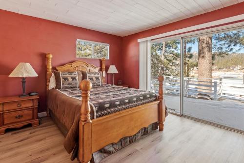 a bedroom with a bed and a large window at Boulder Bay Lakefront Getaway - Across the street from the lake and Boulder Bay Park! in Big Bear Lake