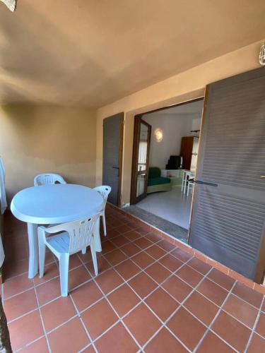 a blue table and chairs in a room with a floor at Villa cesar in Costa Paradiso