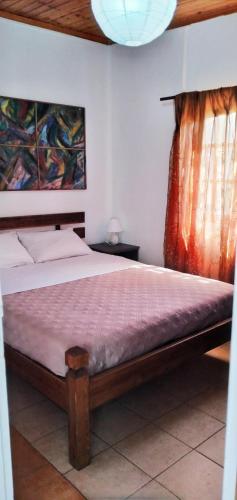 a bedroom with a large bed with at ARTEMIS in Svoronata