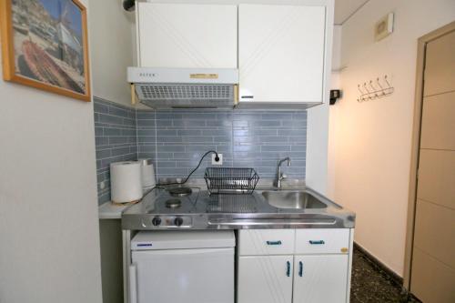 a small kitchen with a sink and a stove at Selana Apartments in Mytilini