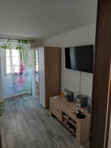 a living room with a flat screen tv on the wall at Atraktivna kuća sa saunom i grijanim jacuzzijem in Cres