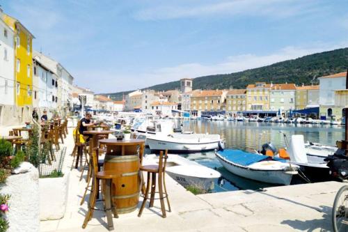 a group of boats are docked in a harbor at Atraktivna kuća sa saunom i grijanim jacuzzijem in Cres