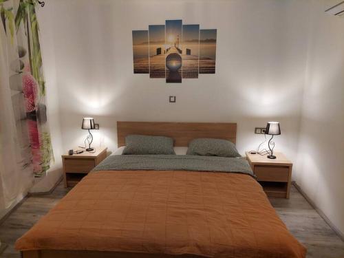 a bedroom with a large bed with two nightstands and two lamps at Atraktivna kuca sa saunom i grijanim jacuzzijem in Cres