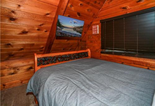 a bedroom with a bed in a wooden cabin at Twin Bear - Cozy and convenient, relaxing cabin with a nice fenced yard and a BBQ in Sugarloaf