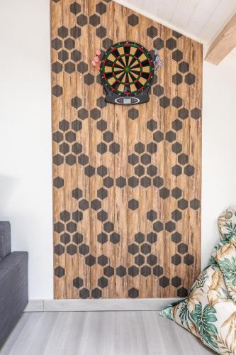 a dart board on a wall in a room at Les Lilas - Confort - Calme - Wifi in Volvic