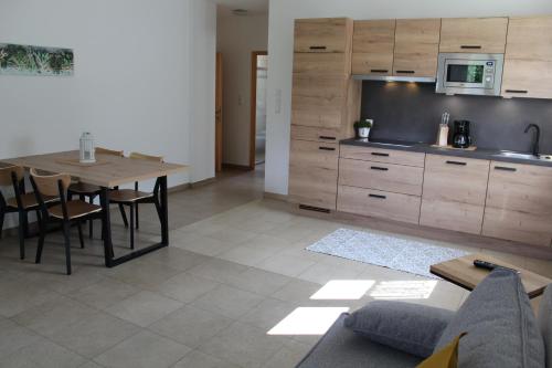 a kitchen and dining room with a table and cabinets at Gartnerhof in Plaus