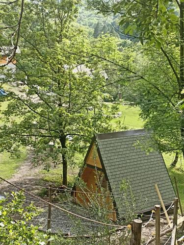 a small cabin in a field with a fence at Baita Eleonora in Argegno