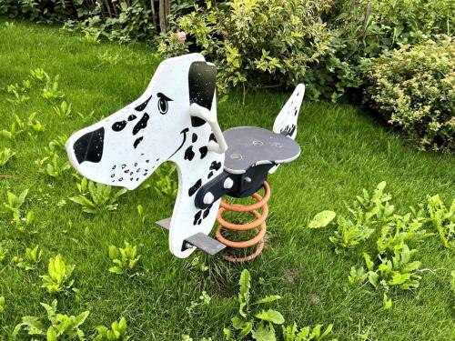 a toy dog with a baseball glove in the grass at Haus am Hügel in Oberkühberg
