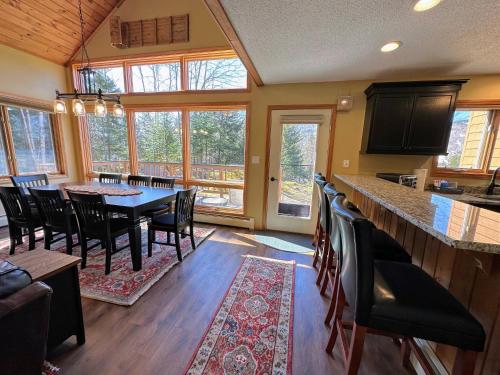 a kitchen and dining room with a table and chairs at New Property! Updated 3 bed 3 bath condo with mountain ski slope views in Bretton Woods in Bretton Woods