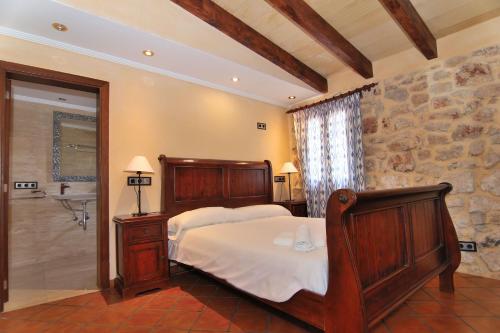 a bedroom with a bed and a stone wall at 243 Villa Can Bassa ETV3623 by Mallorca Charme in Muro