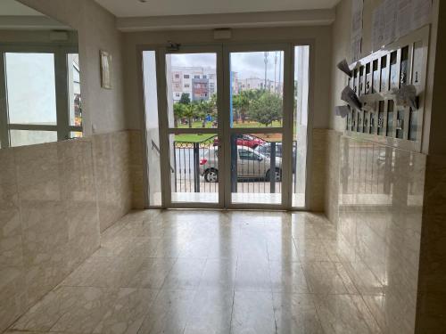 an empty lobby with a door to a parking lot at Spacious appartement of two rooms close to morocco mall in Casablanca