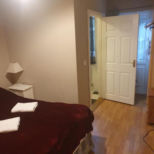 a room with a bed and a white door at John Street Guest House in Kilkenny