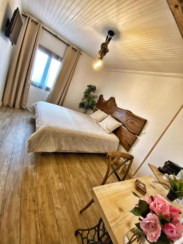a bedroom with a bed and a table at U PASTURELLU in Pioggiola