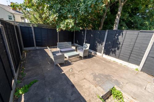 a patio with two chairs and a table and a fence at STAY SA Spacious studios next to UOB and 10min to the City! in Birmingham