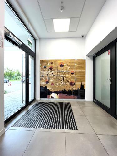 a room with a glass door and a floor at Zarembowicza Apt 38 - Self Check-In 20h - Parking &Lift in Wrocław