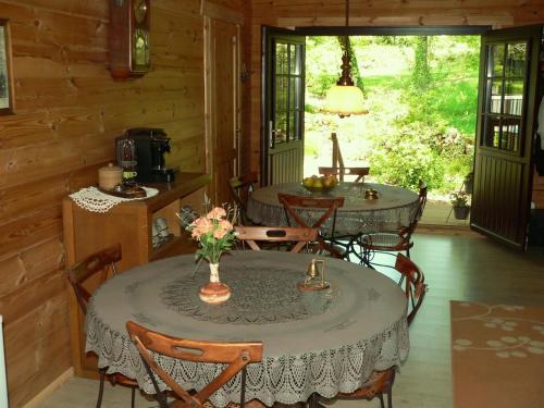 une salle à manger avec une table et des chaises dans une cabine dans l'établissement Chambre d'hôte L'Arrivée, à Autoire
