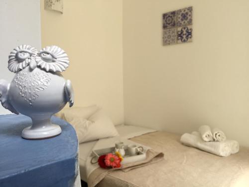 a bedroom with a bed with a statue of a chicken on it at La Casetta 19 in Polignano a Mare