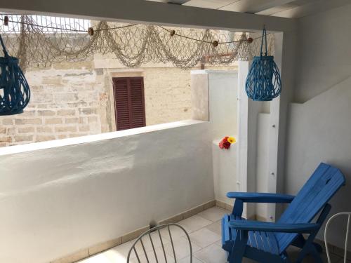 a room with two blue chairs and a window at La Casetta 19 in Polignano a Mare