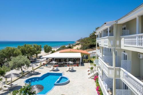 an aerial view of a resort with a swimming pool and the beach at Boutique Giannikis By The Beach in Limenaria