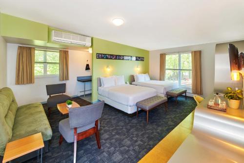 グリーンポートにあるGreenporter Hotelのベッドとソファ付きのホテルルーム