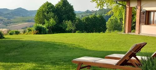 a chair sitting on a lawn with a view at Villa Pieve in Moncalvo