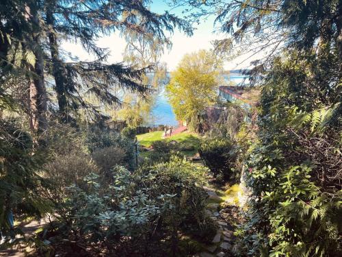a path through a garden with a view of the water at Sanctuary Seaside in Eastsound