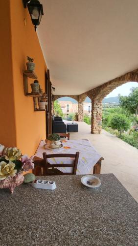 a dining room with a table and a view of a room at Paraiso Sardo 1 in Villasimius