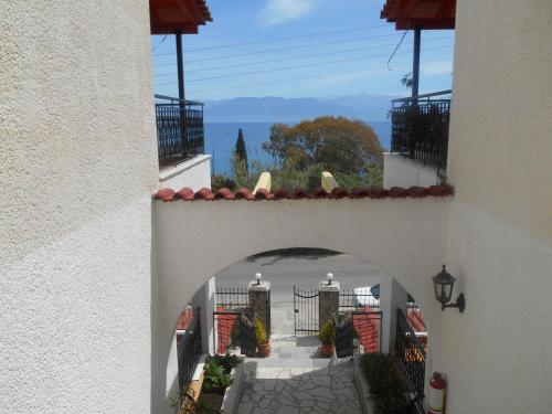 an entrance to a building with an archway at Melios Rooms in Petalidhion