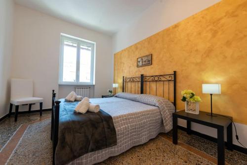 a bedroom with a bed and a yellow wall at Casa Daniele - Centralissima sul porto di Rapallo in Rapallo
