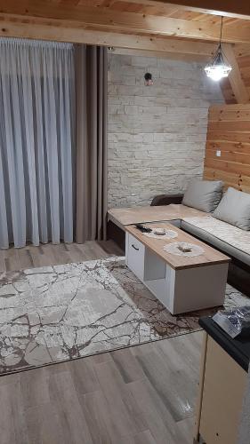 a room with a bed and a desk in it at House Bojana in Žabljak