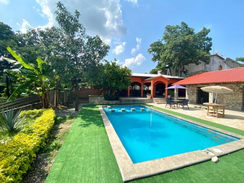 a swimming pool in the yard of a house at Azomalli Hotel Boutique in Damían Carmona