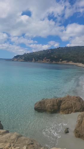 a view of a beach with rocks and the ocean at Paraiso Sardo 1 in Villasimius