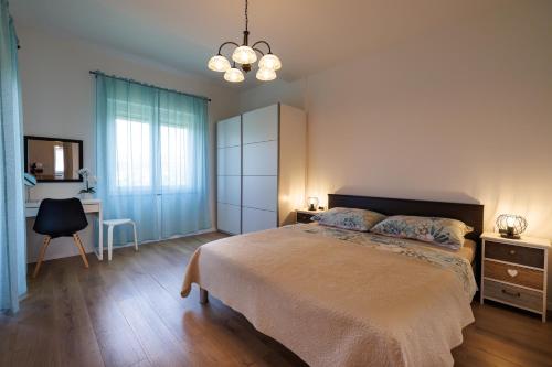 a bedroom with a bed and a desk and a chair at Apartment Karmen in Šilo