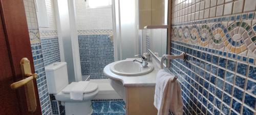 a bathroom with a sink and a toilet at Bermeo Kaia in Bermeo