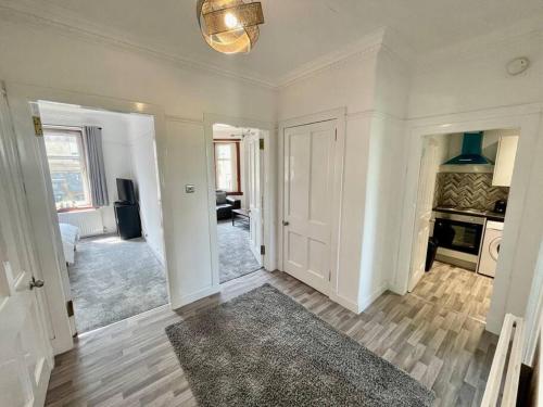 a white room with a hallway with a living room at Large 2 bed near Glasgow Airport in Paisley