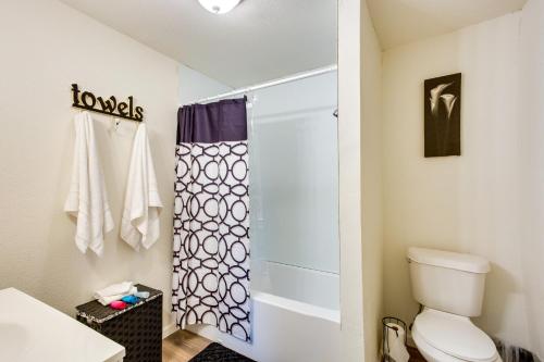 a bathroom with a toilet and a shower at Thackerville Getaway with Porch - Near WinStar! in Thackerville