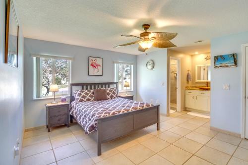 a bedroom with a bed and a ceiling fan at Waterfront Merritt Island Vacation Rental with Pool! in Merritt Island