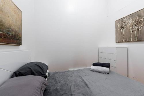a bedroom with a bed with a gray blanket at Cozy Apt 3BR/2Baths in NYC in New York