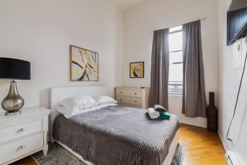 a small bedroom with a bed and a window at Cozy Apt 3BR/2Baths in NYC in New York